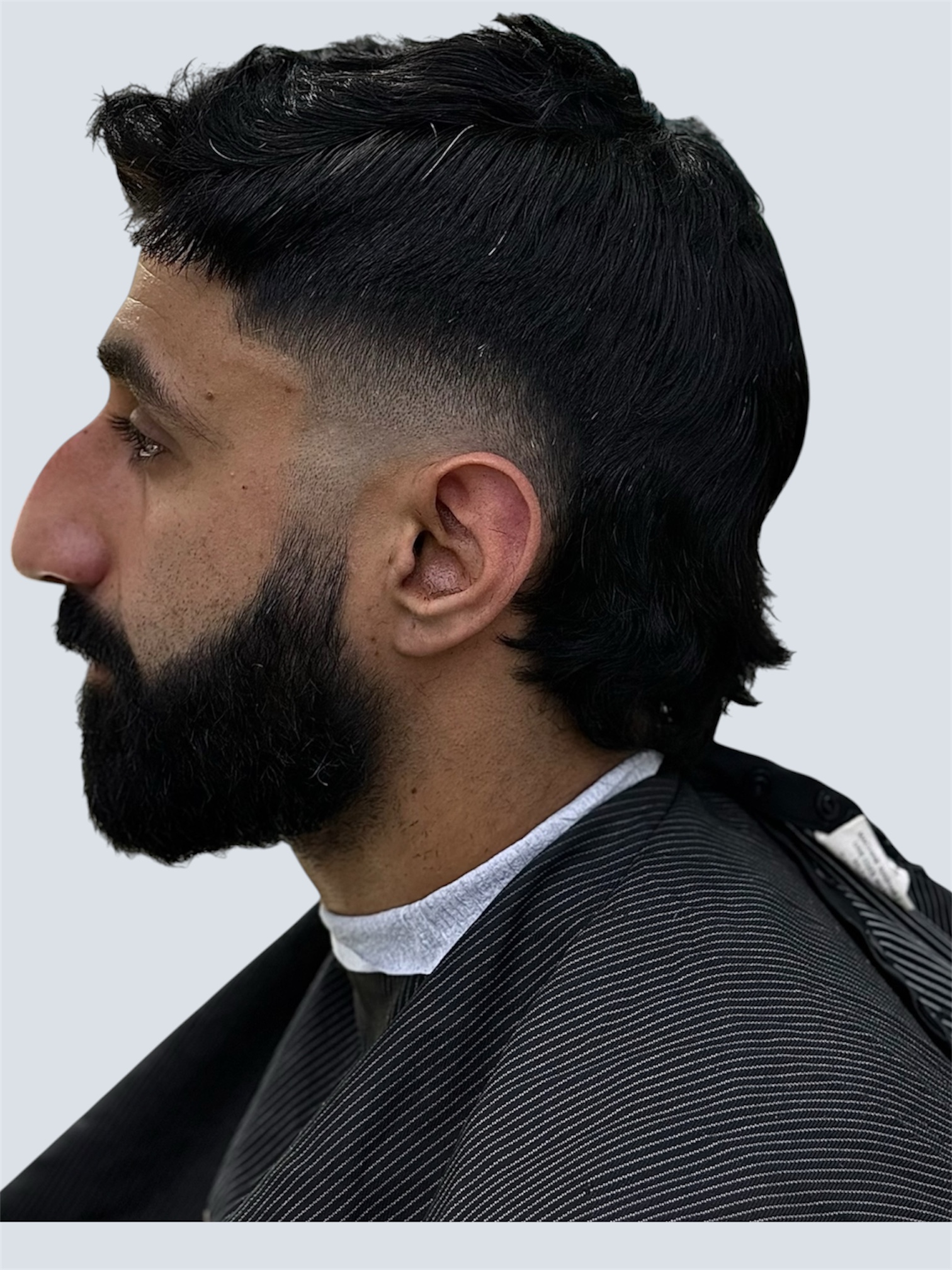 Long layered fade with beard, styled at Fortis Barber Shop