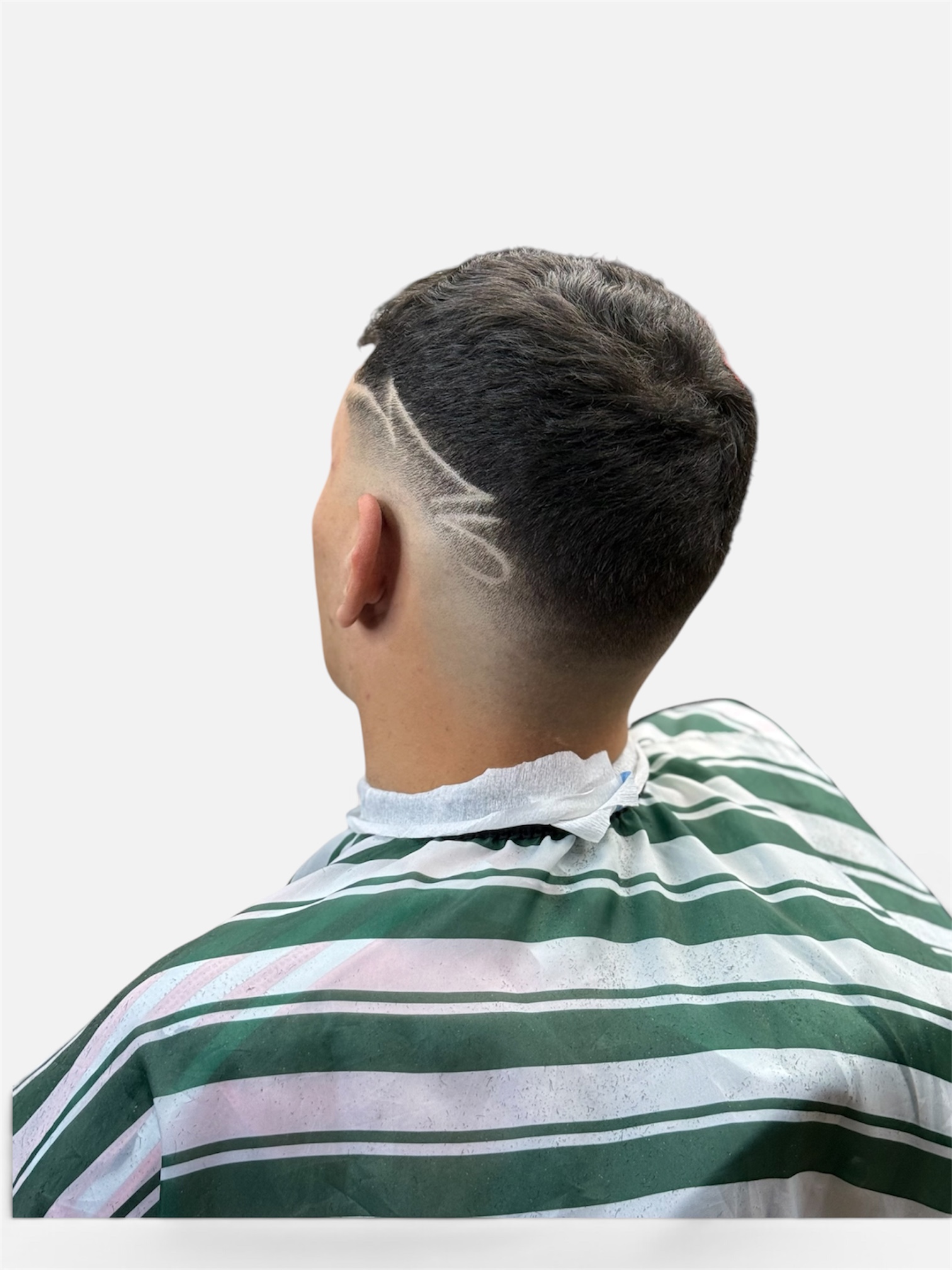Curly top skin fade with hair design at Fortis Barber Shop