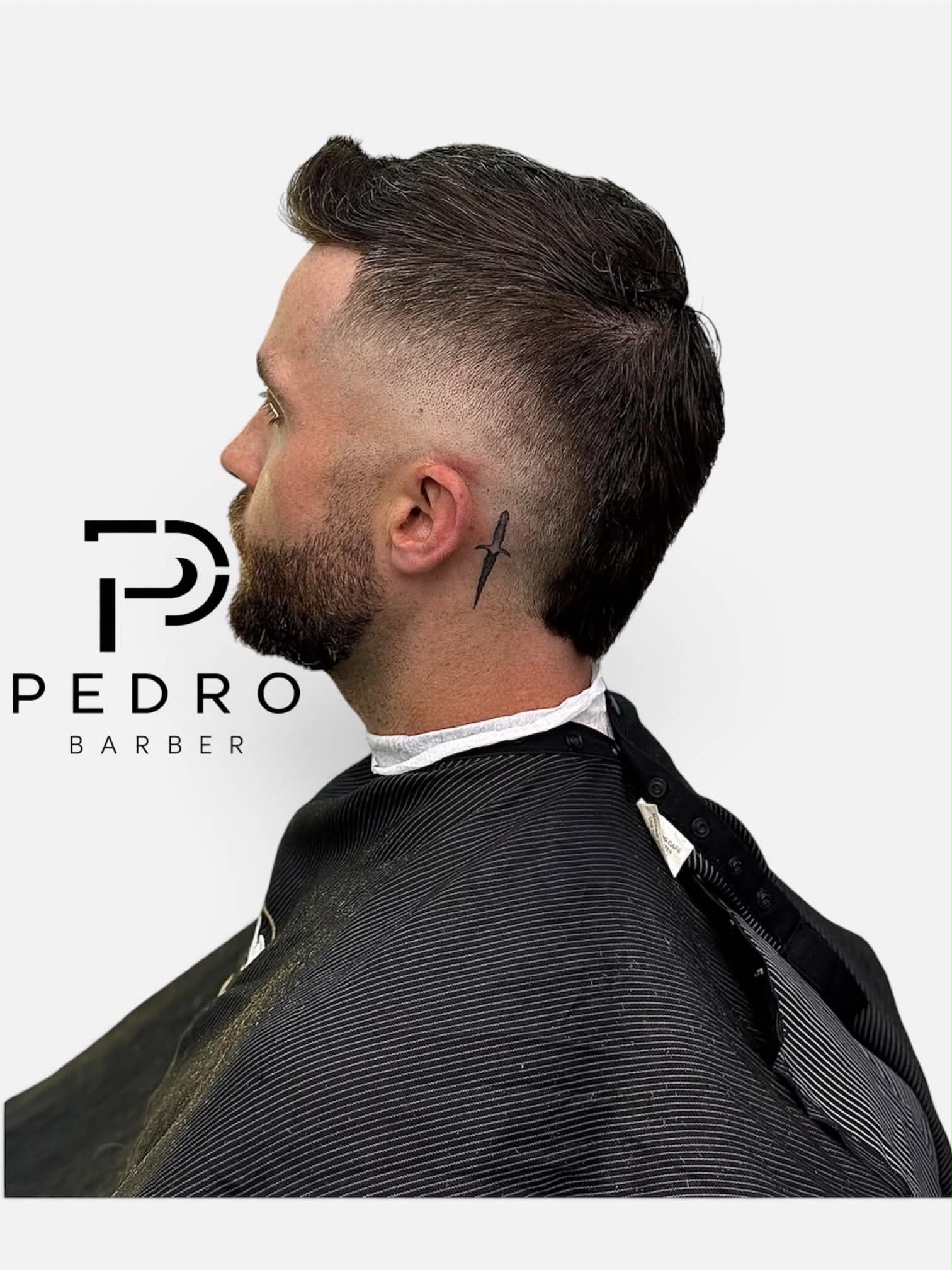 Textured pompadour with tattoo detail, cut by Pedro